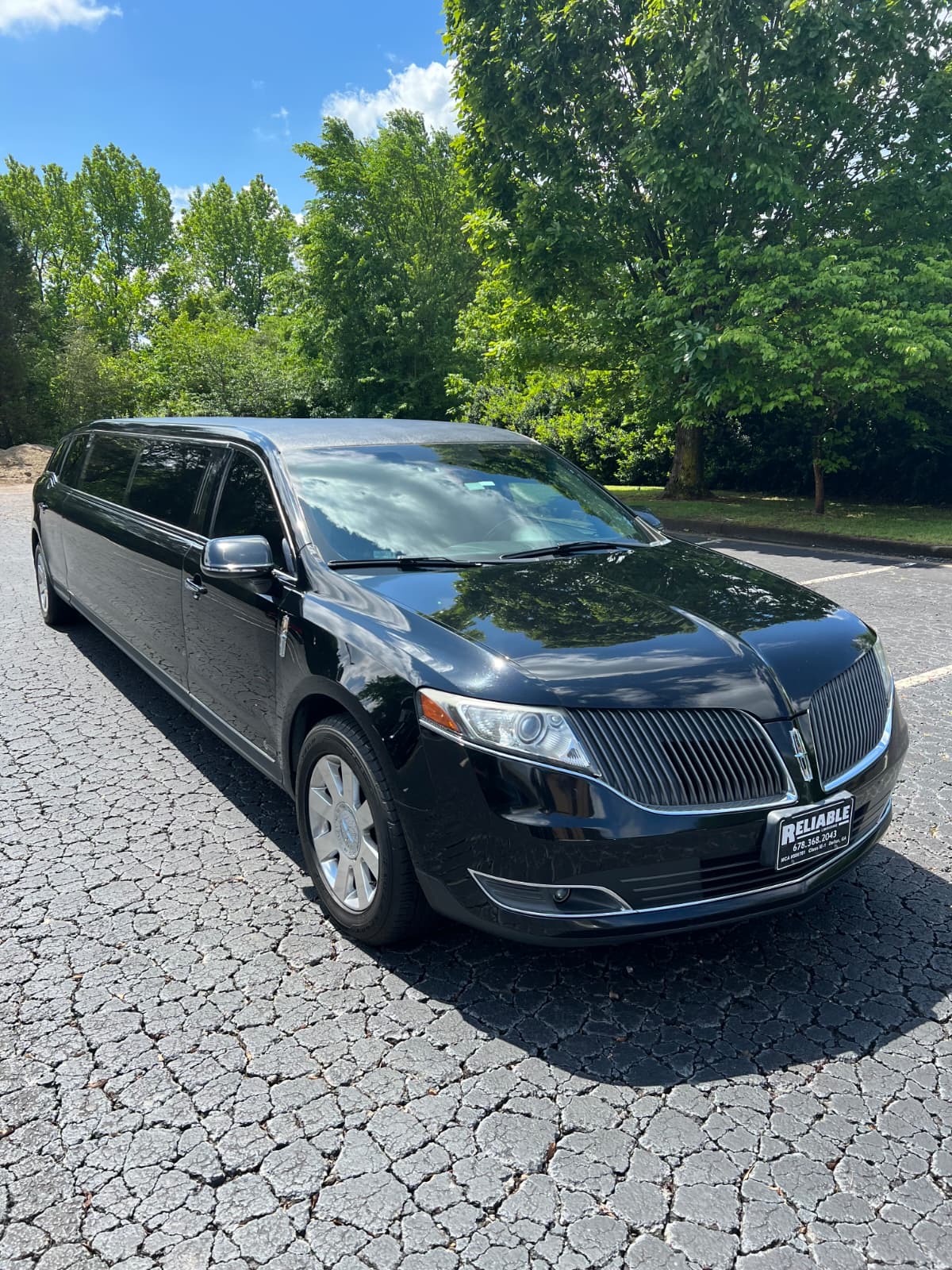 Black luxury sedan with chauffeur in Atlanta showing black car service cost